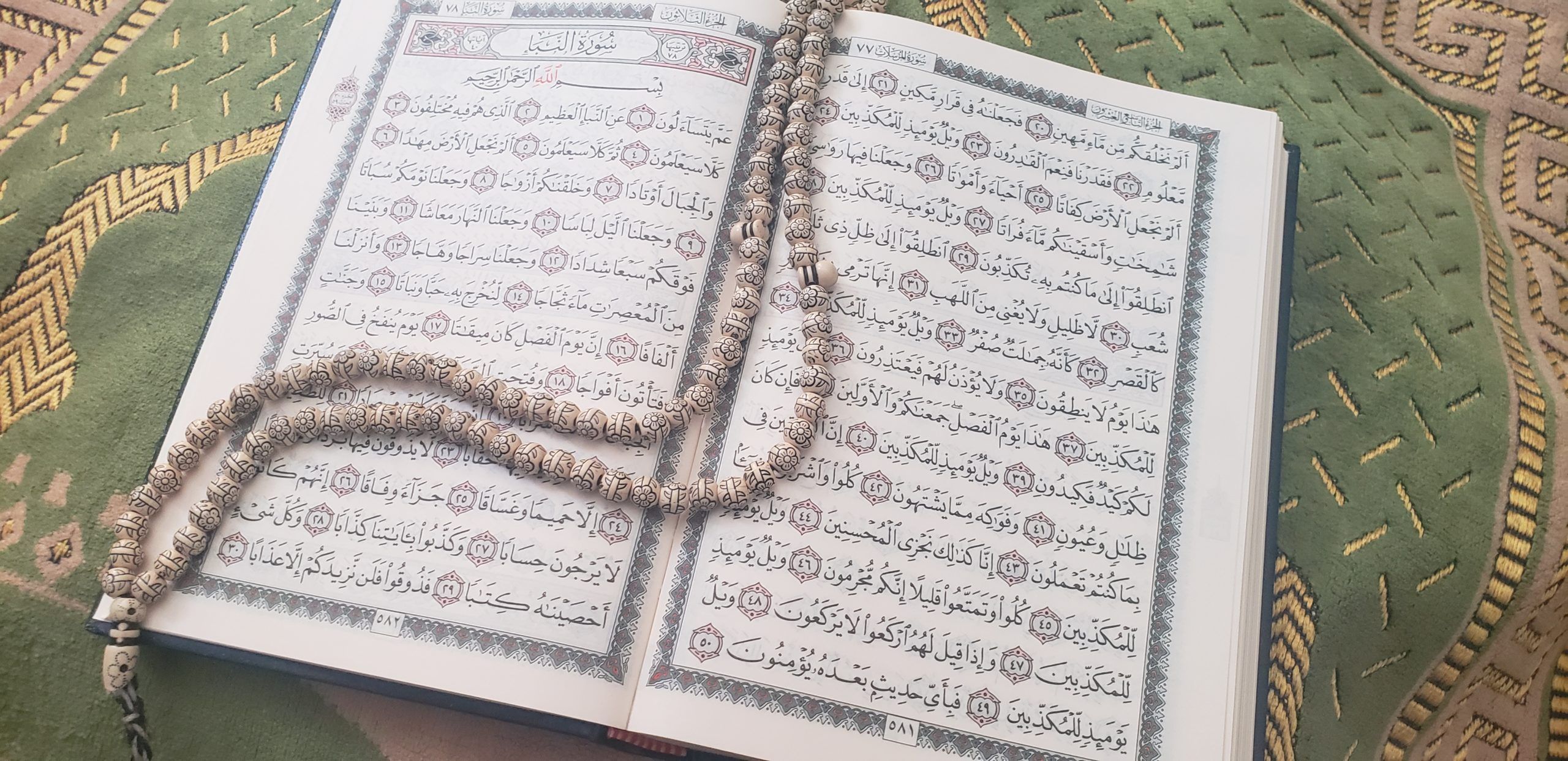 Muslim prayer beads on open Quran over prayer mat. One of Grandma's lessons was that she lived by prayer