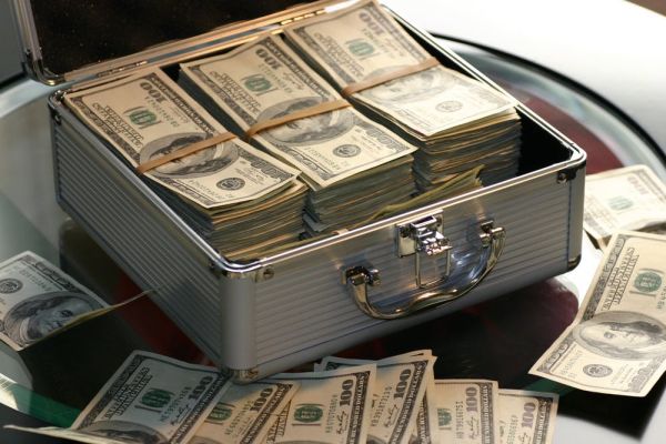 An open case of dollar notes; our beliefs about money need to change